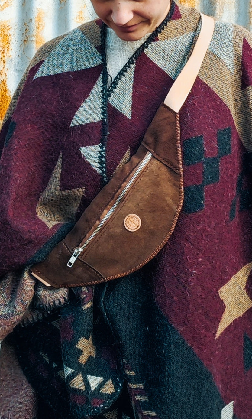 Sac bandoulière banane au style western portée par une femme cavalière gaucho